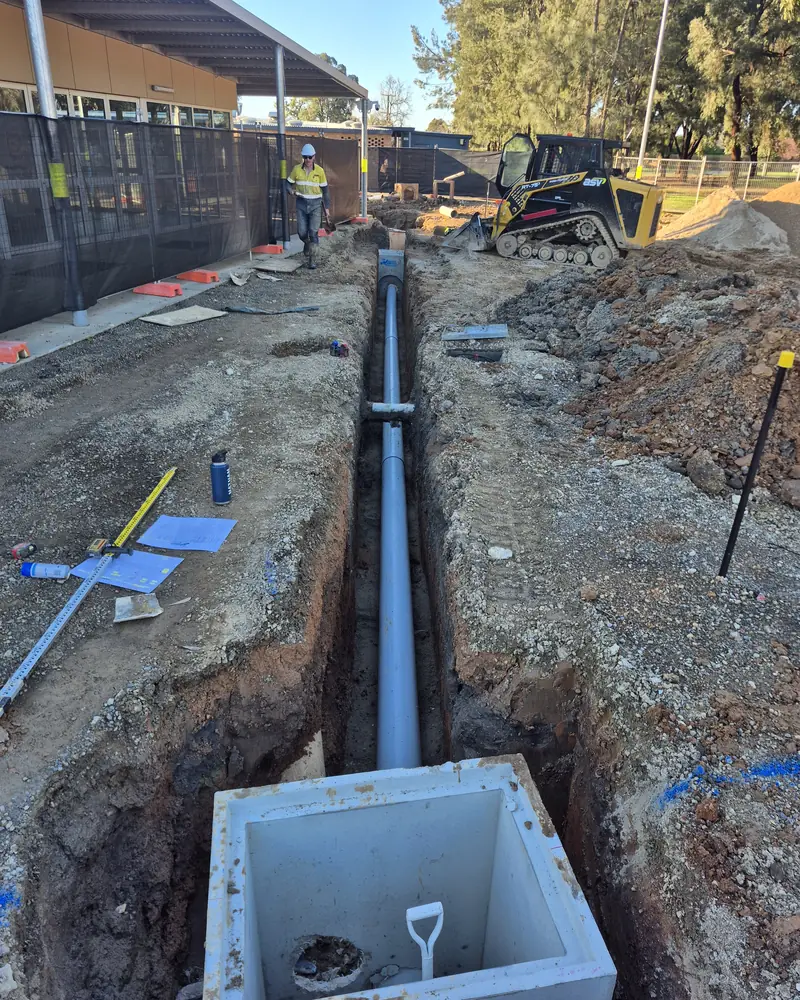Stormwater pipe laid in a trench to a precast pit on a commercial site